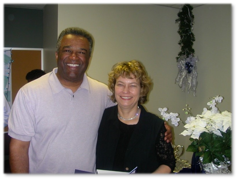 Photograph of blog post contributor Janise Fessenden on the right posing at an event with former King County Executive, Ron Sims
